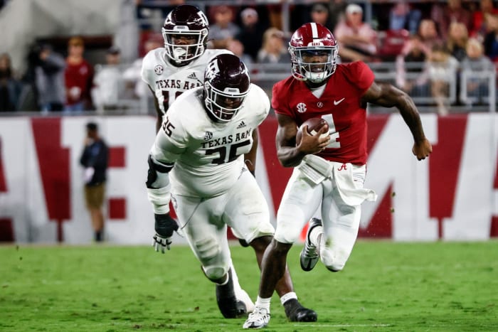Alabama Crimson Tide quarterback Jalen Milroe (4) scrambles away from Texas A&M Aggies defensive lineman McKinnley Jackson (35) during the first half at Bryant-Denny Stadium.